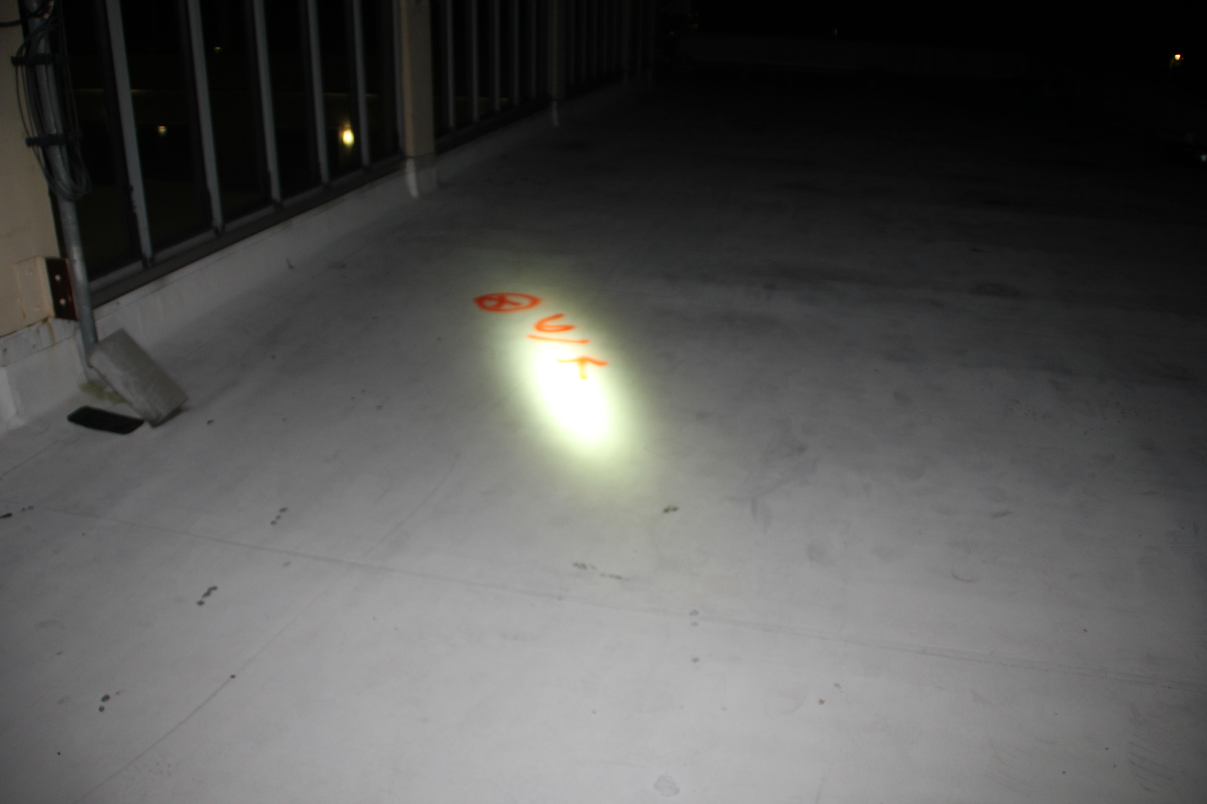 Nighttime roof moisture survey with marked wet spot on commercial flat roof - infrared inspection by Weller Infrared Services